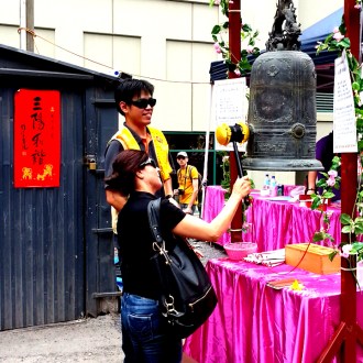 Anglo-Australian woman rings a Buddhist bell at the Lunar Festival, Melbourne, 2015