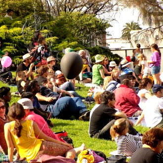 Families sit on the grass during the Wominjeka Festival 2015