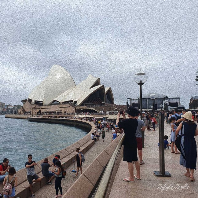 People walking in Circular Quay, Sydney, with the Sydney Opera House in the background