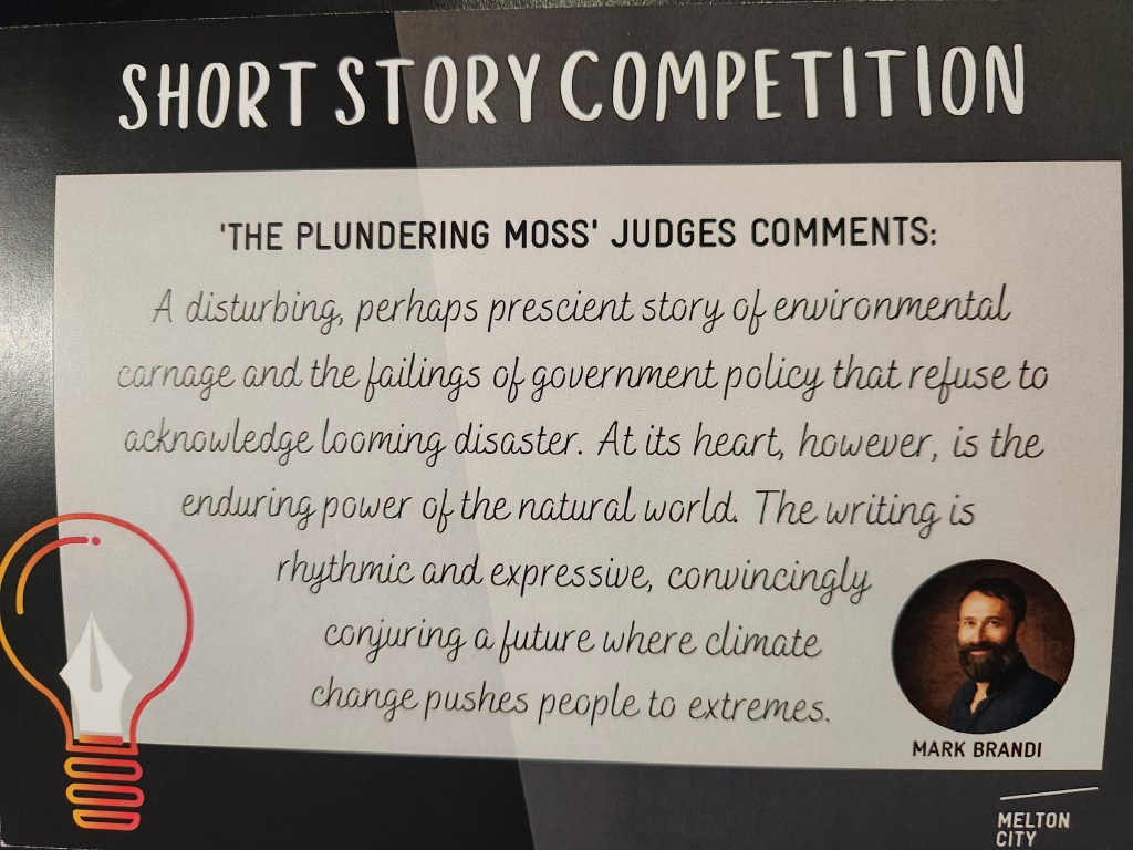 A black card with writing, titled "Short Story Competition," showing a light bulb and quill pen tip in the bottom left corner, and Mark Brandi's headshot and the Melton City LIbraries logo on the right corner. Title reads: 'The Plundering Moss' Judges Comments (as per post)